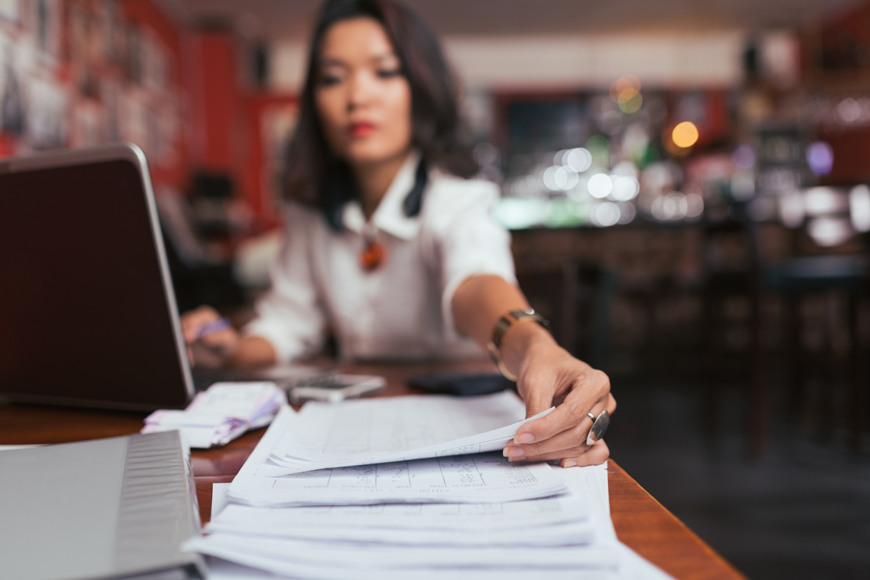 Business lady working with financial documents on her desk. Concept: tax tips