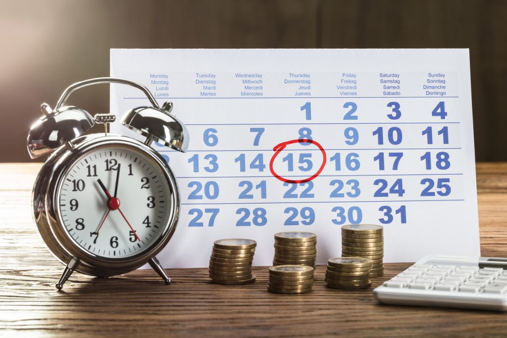 Clock, stacks of coins and calendar with a payment due date, to illustrate the idea of removing a late payment from a credit report.