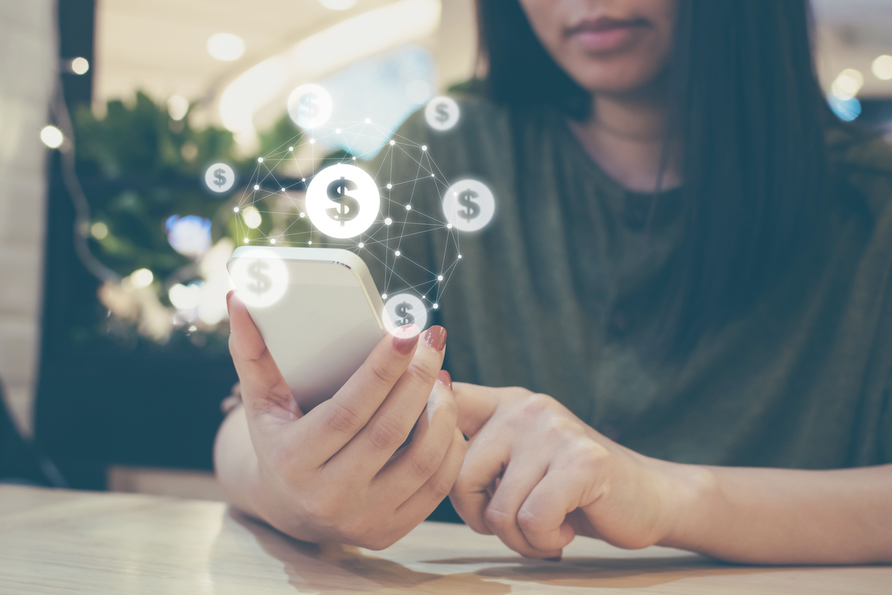 Woman hand using mobile phone and showing dollar signs. Concept: credit score and interest rate.