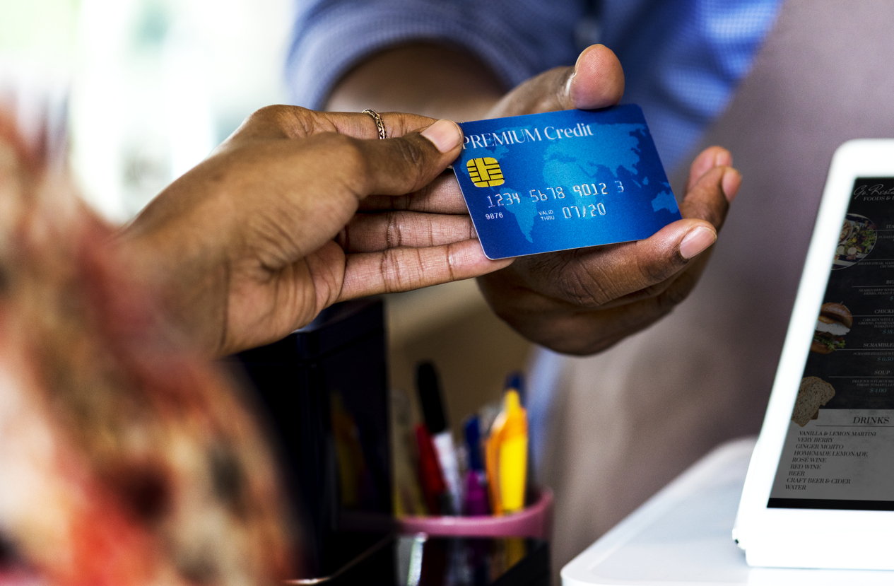 two hands holding a business credit card