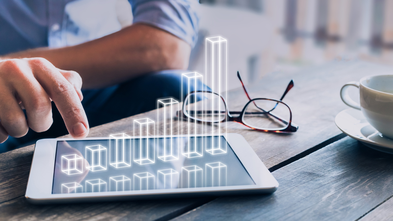 Businessman analyzing growing 3D AR chart floating above digital tablet computer screen, showing successful increase in business profit. Concept: expense tracker apps