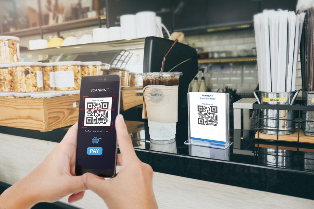 Man scaning tag in Coffee shop accepted generate digital pay without money. Concept: PayPal