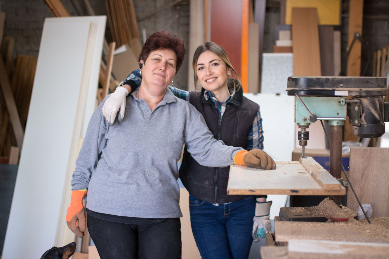 Mother and daughter in a wood workshop. Concept: family business.