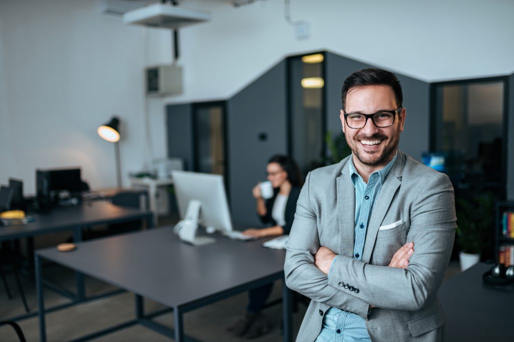 Successful businessman looking at camera with arms crossed. Concept: how to be a good boss