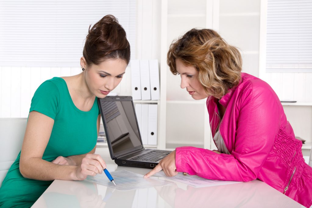 Female business owner meeting with female accountant in office and using laptop. Concept: Cash Flow Management