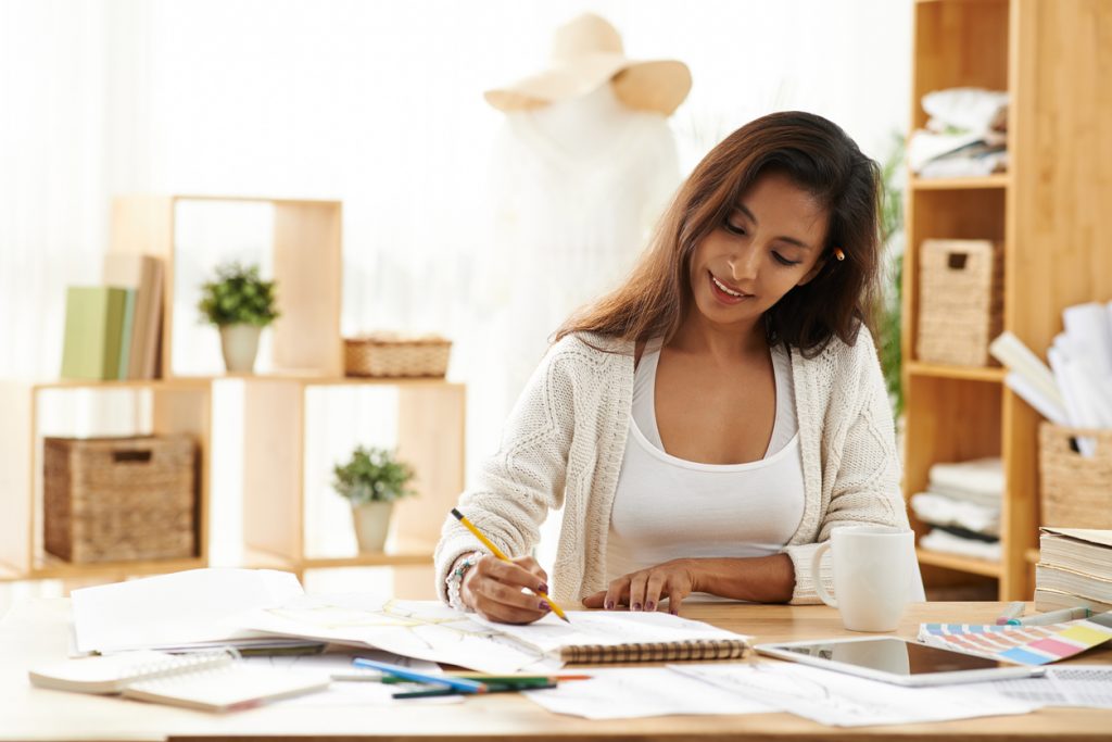 Female business owner in her office working on her business proposal. Concept: How to write a business proposal