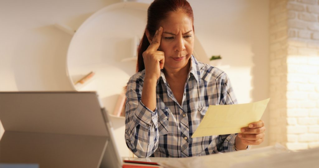 Latina business owner having cash flow problems and trying to solve them. Concept: cash flow problems and solutions