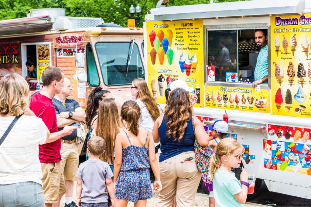 Ice Cream truck and people in queue buying. Concept: seasonal business and business loan