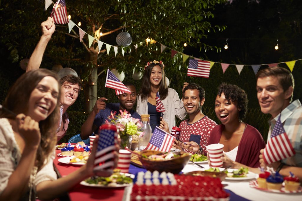Portrait Of Friends celebrating the 4th Of July Holiday at a Backyard Party. Concept: how to increase sales during the 4th of july