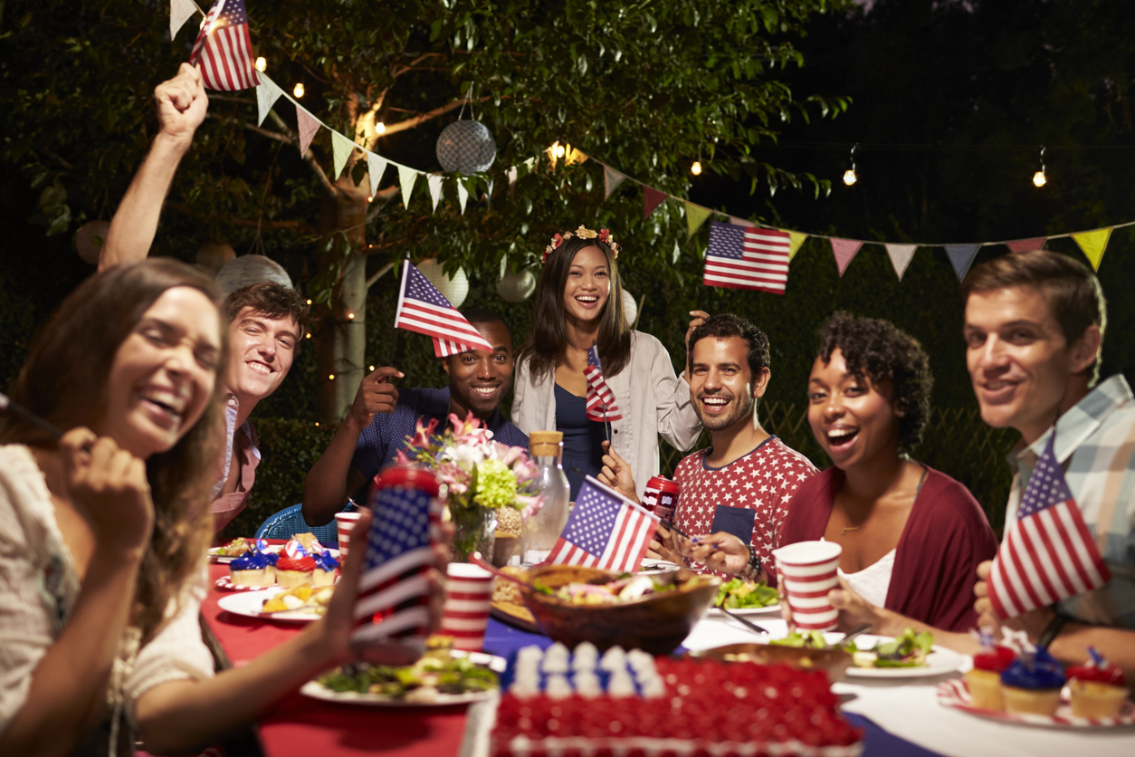 Portrait Of Friends celebrating the 4th Of July Holiday at a Backyard Party. Concept: how to increase sales during the 4th of july