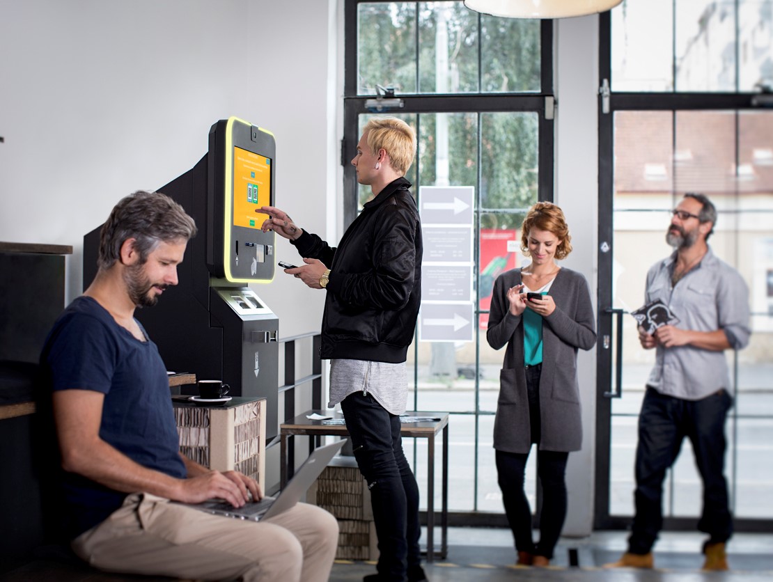 People stand at an ATM in their local bank hoping to get cash from their small business bank account. Concept: Why You Should Have A Small Business Bank Account
