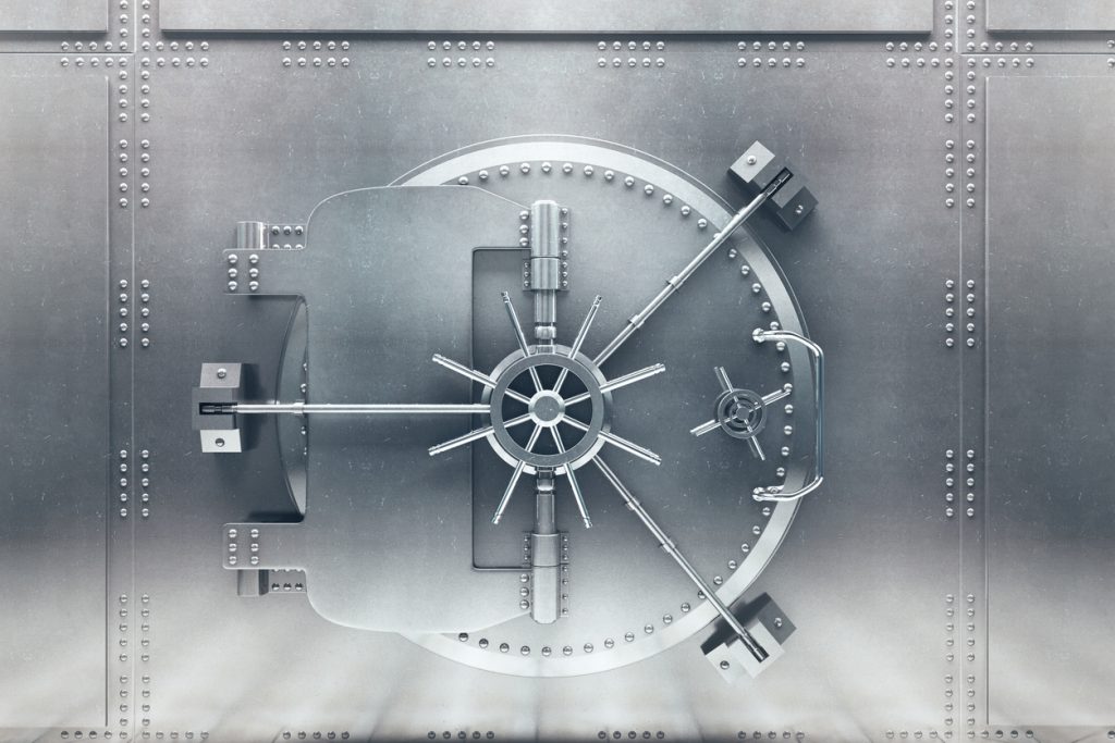 Front view of light silver bank vault door, closed. Bank technology to keep information safe and secure. Concept: How does Camino Financial use bank technology to offer the best loan process?