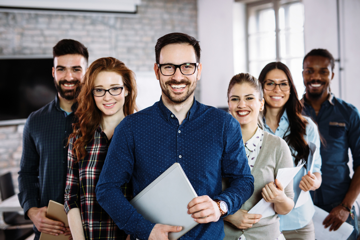 Portrait of successful young business team posing in office. Concept: contractor vs employee: what's the difference?