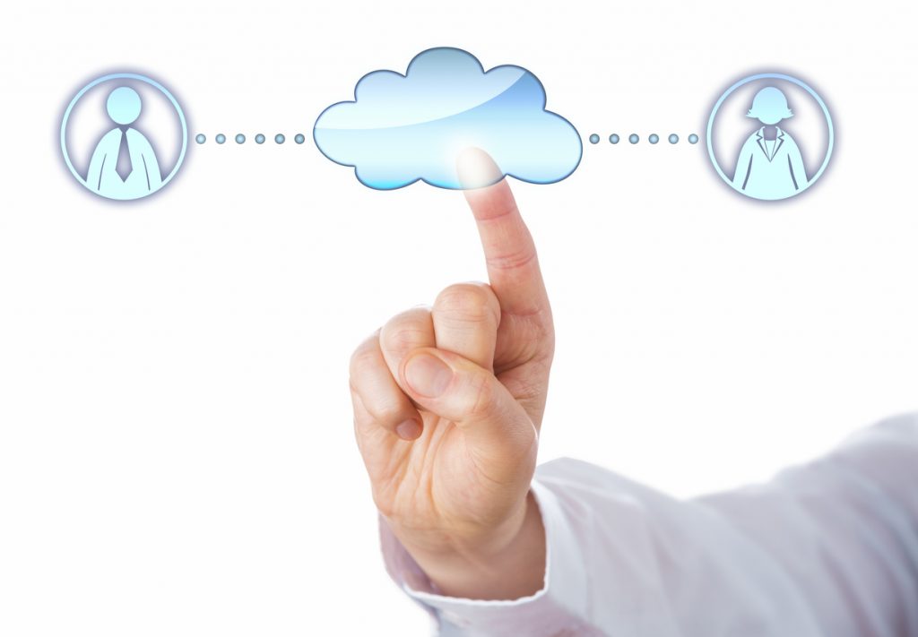 Close up of an index finger touching a cloud icon to connect with a female and a male professional peer in cyberspace. Metaphor for peer-to-peer lending.