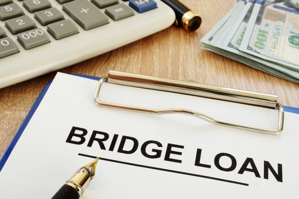 Bridge loan form and clipboard on a desk. Concept: bridge loan