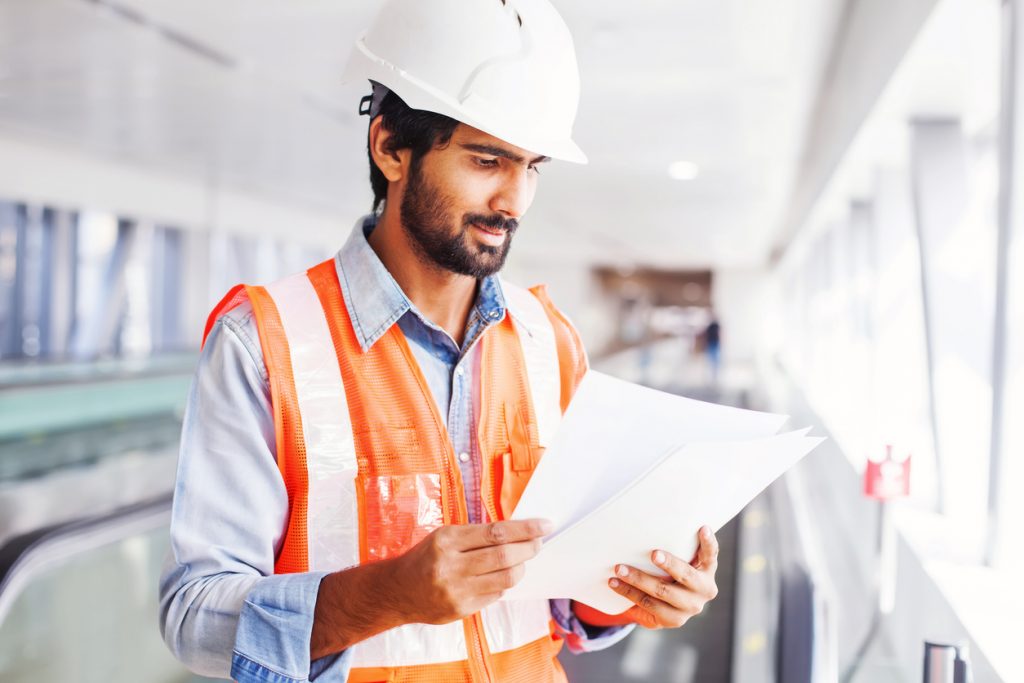Young engineer holding contract. concept: construction company revenue