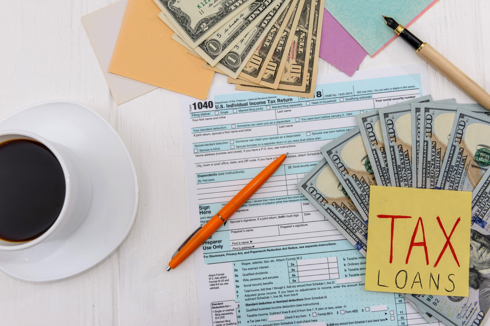 Tax declaration with dollars and coffee top view. Concept: tax loans