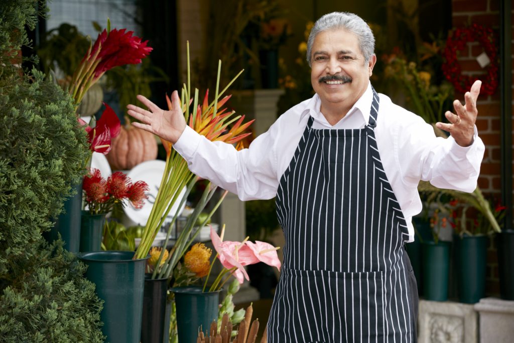 Portrait Of Male Florist Outside Shop Smiling To Camera. Concept: increase profit margin