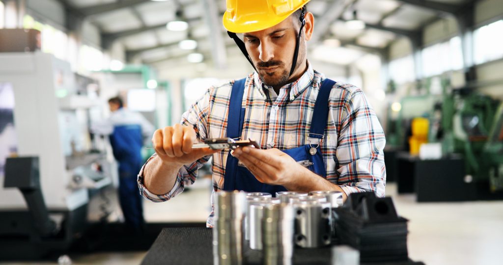 Industrial factory worker working in metal manufacturing business. Concept: What happens to your business if you get deported?