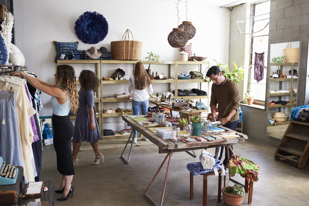 Customers and staff in a busy aternative clothes shop. Concept: community help and increase profits