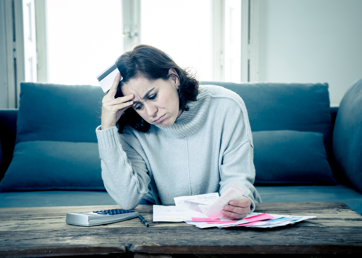 Young attractive woman looking stressed and worried with card payments and home finances accounting costs charges taxes and mortgage in paying bills financial problems and credit card debts concept. concept: business loan