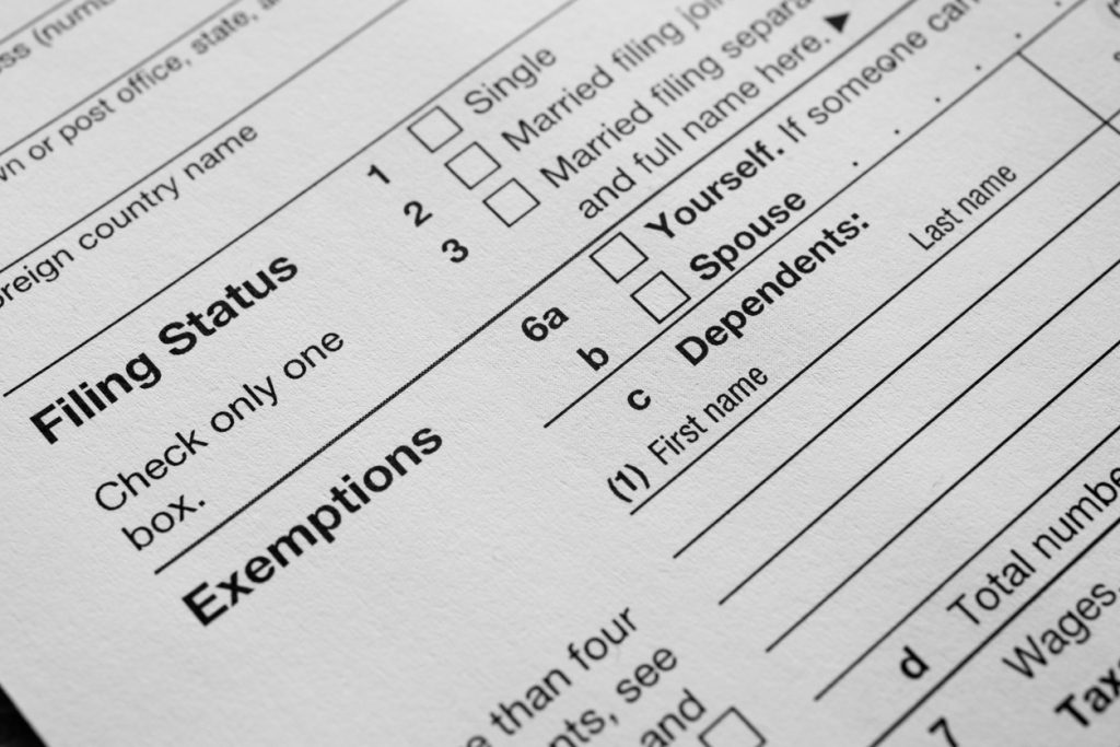 US Income tax return 1040 close up filing status and exemptions. concept: What happens if you file taxes late?