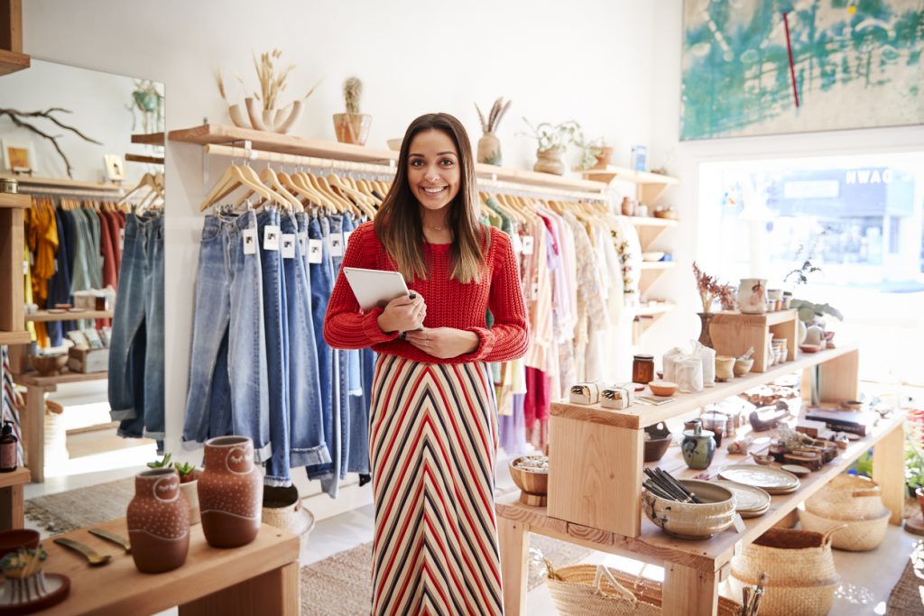 Portrait Of Female Owner Of Independent Clothing And Gift Store With Digital Tablet. concept: How to File Taxes for the First Time