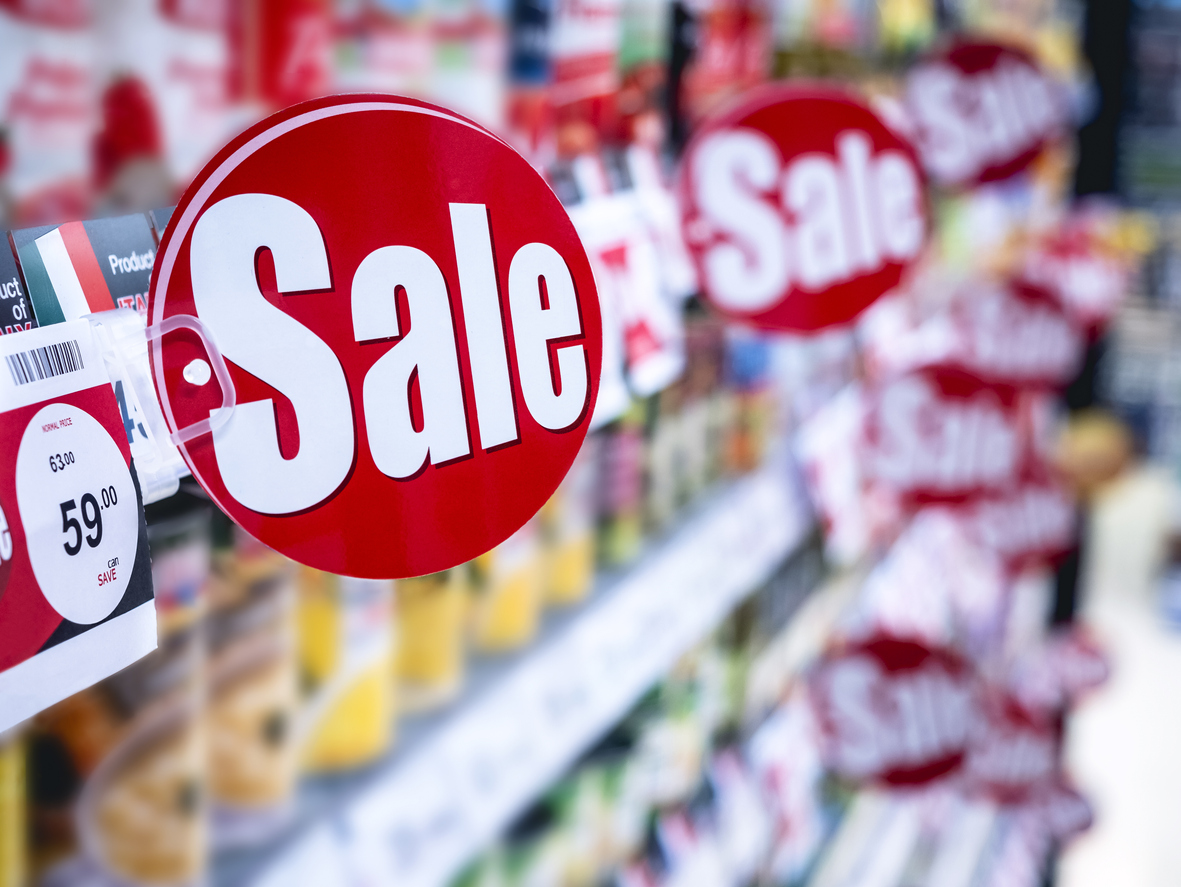 Sale signage in store aisle. Concept:How to price your products for Black Friday