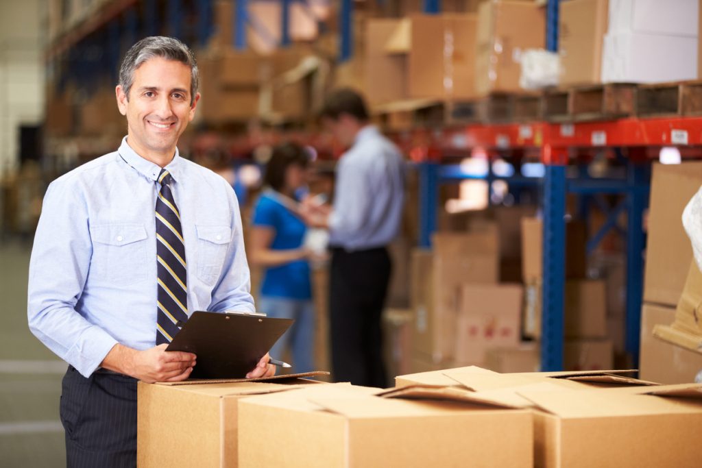 Manager In Warehouse Checking Boxes . Concept: fixed expenses