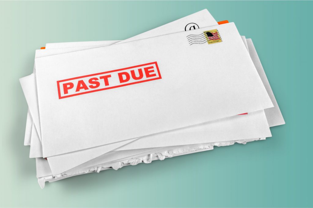 Pile of envelopes with overdue utility bills. concept: back taxes