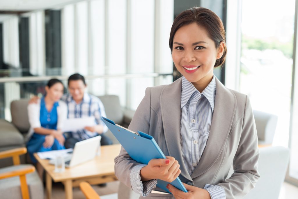 Portrait of cheerful real estate agent with a clipboard. concept: loan broker
