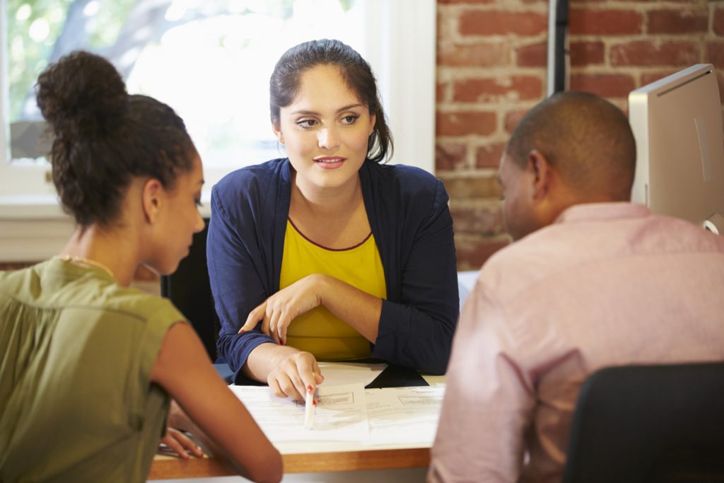 Couple meeting with a tax preparer filing their taxes