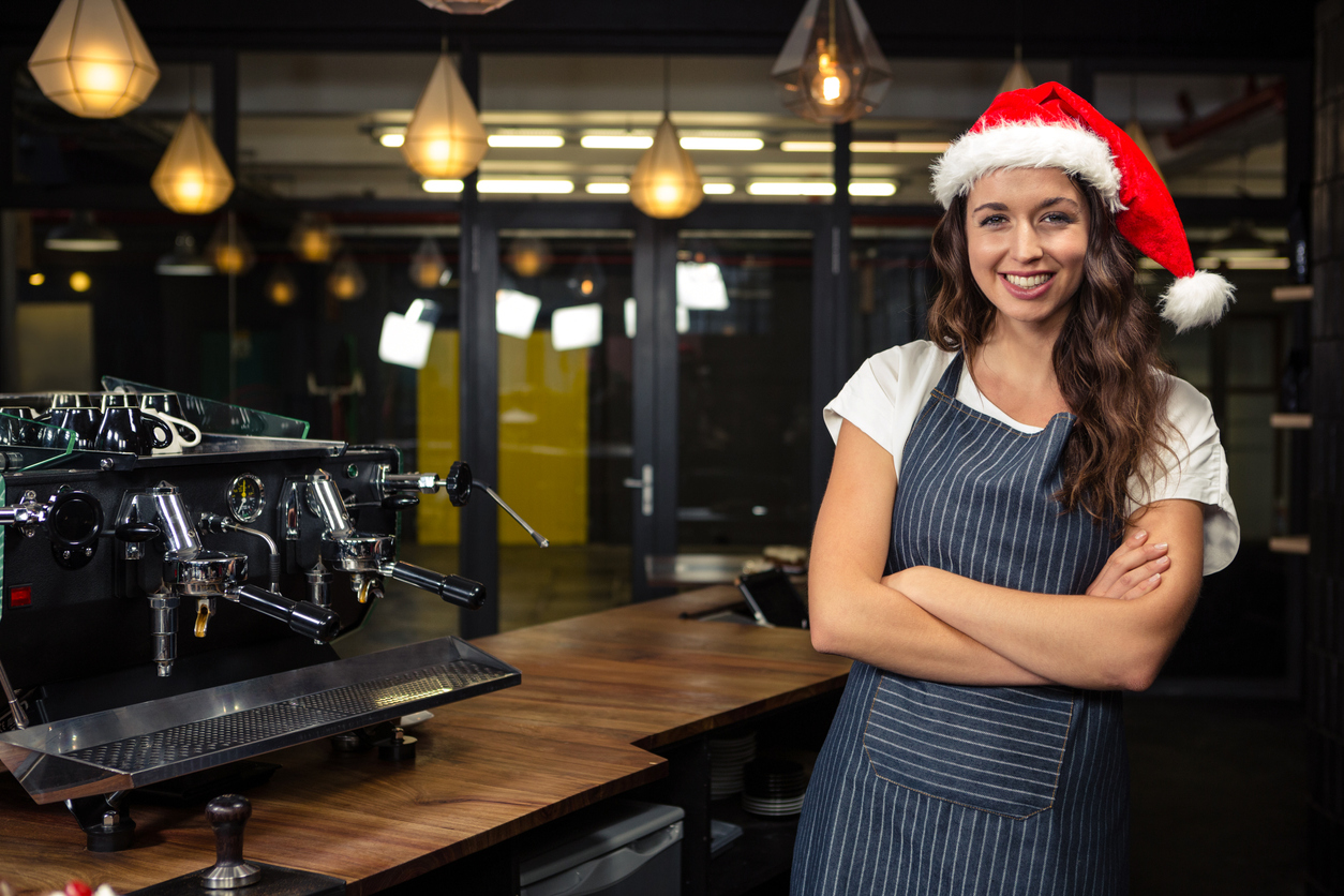 Restaurant owner wearing santa hat. Concept: Restaurant work-life balance during the holiday season