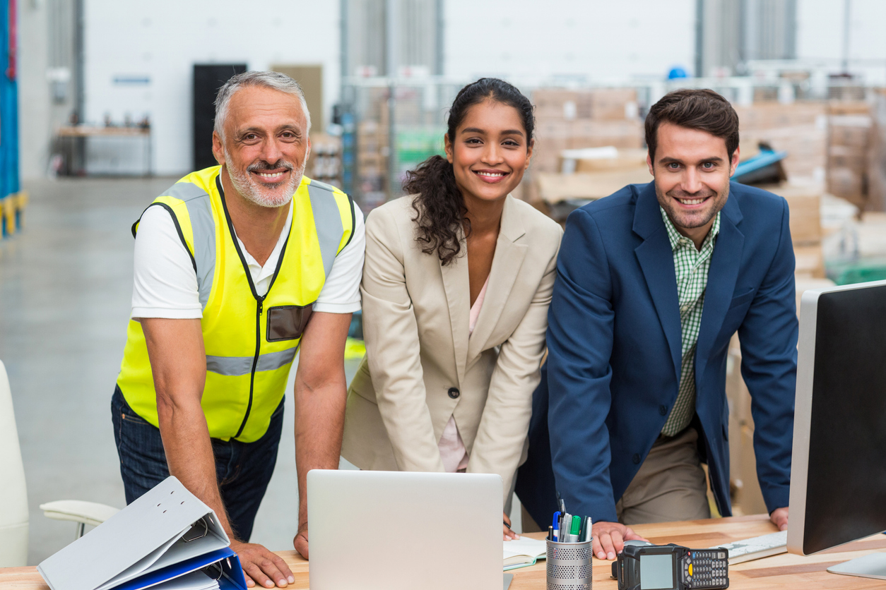 Portrait of warehouse managers and worker working together in warehouse office