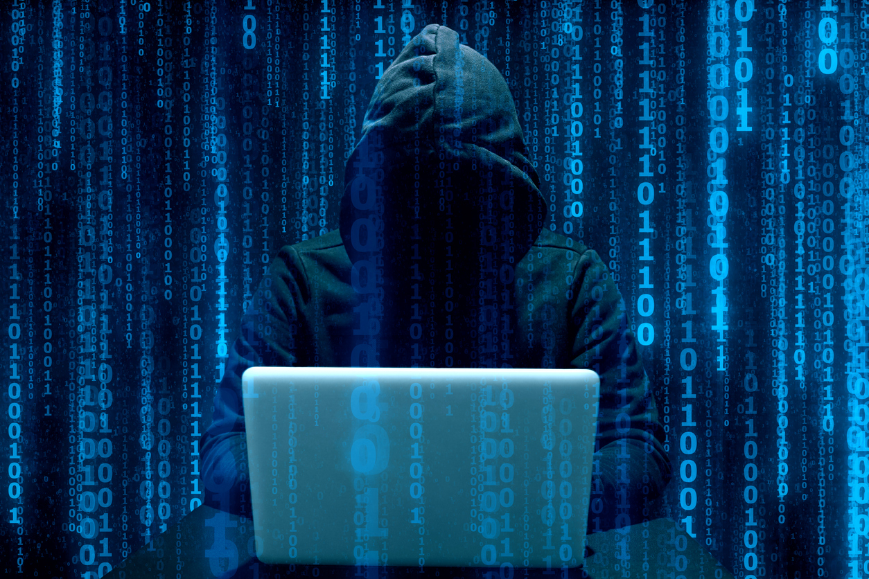 Faceless hooded anonymous computer hacker. Concept: cyber liability insurance