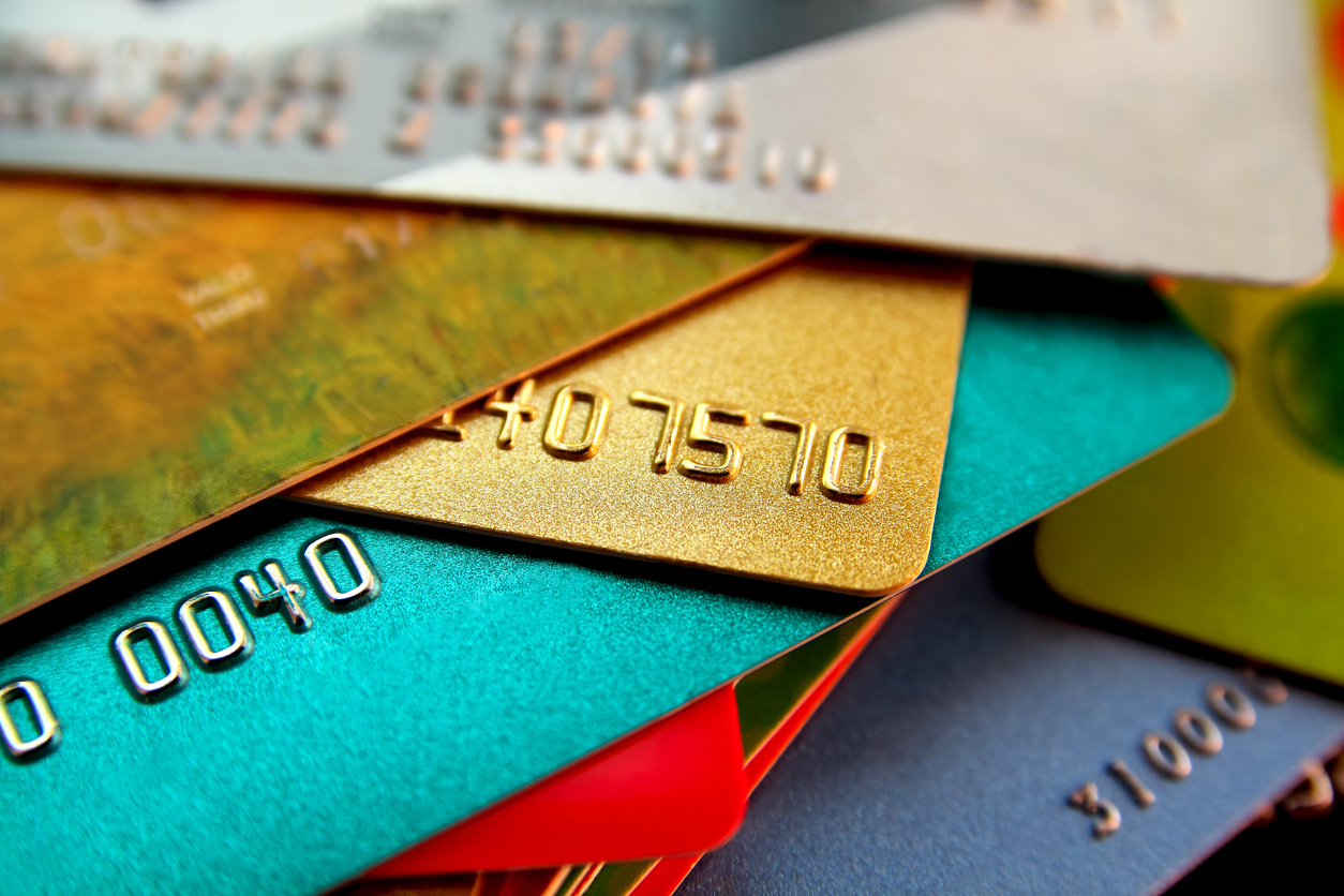 stack of multicolored credit cards, close up view with selective focus. concept: Secured vs Unsecured Credit Cards