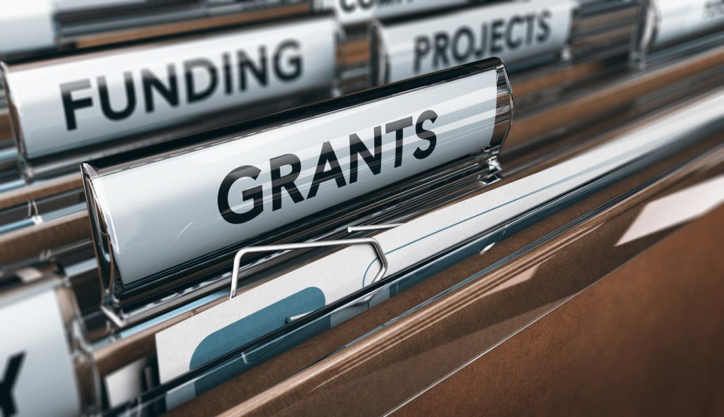 View of brown folders, with focus on grants label, Concept of funding, 3D illustration. concept: SBA grants