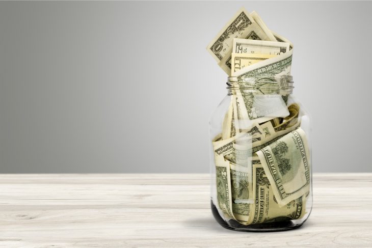 Glass jar for money on background. concept: investment accounts