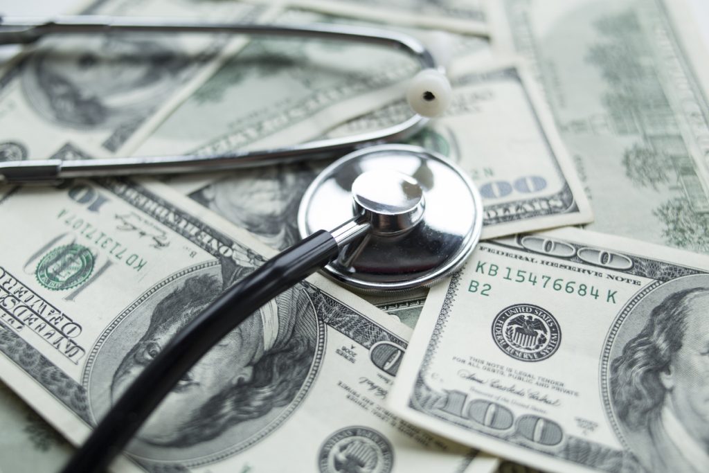 Medical costs. Stethoscope on the dollars. concept: medical loans