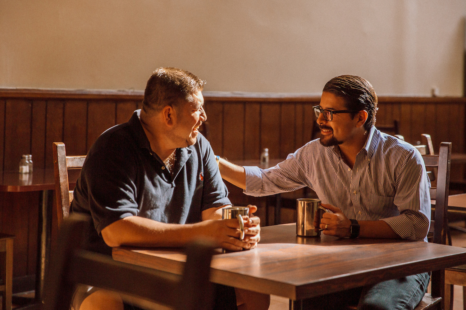 Sean Salas, CEO of Camino Financial, with business owner. Concept: Camino Financial message on Coronavirus