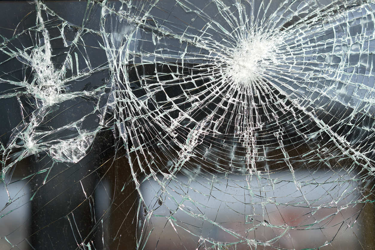 destroyed window of a railway carriage. concept: protest relief